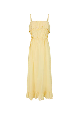 A woman modeling a pale yellow strapless maxi dress with ruffle details